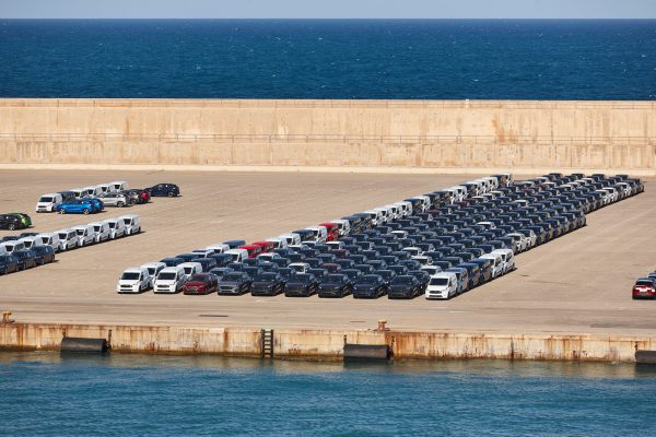 New vehicles in parking lot ready to be shipped. Motor industry